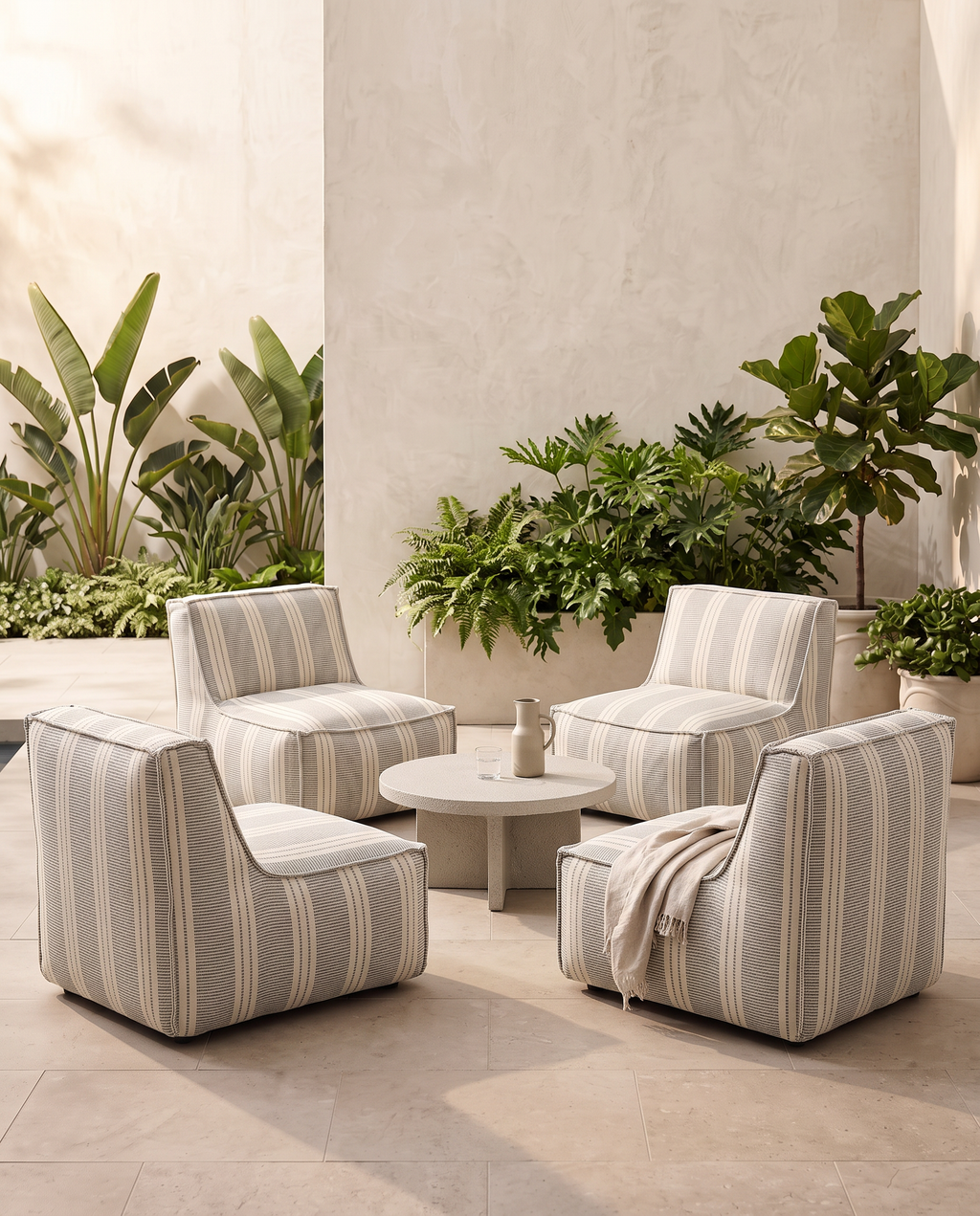 Outdoor setting featuring the Cove lounge chair in blue and ivory Dobby Stripe fabric