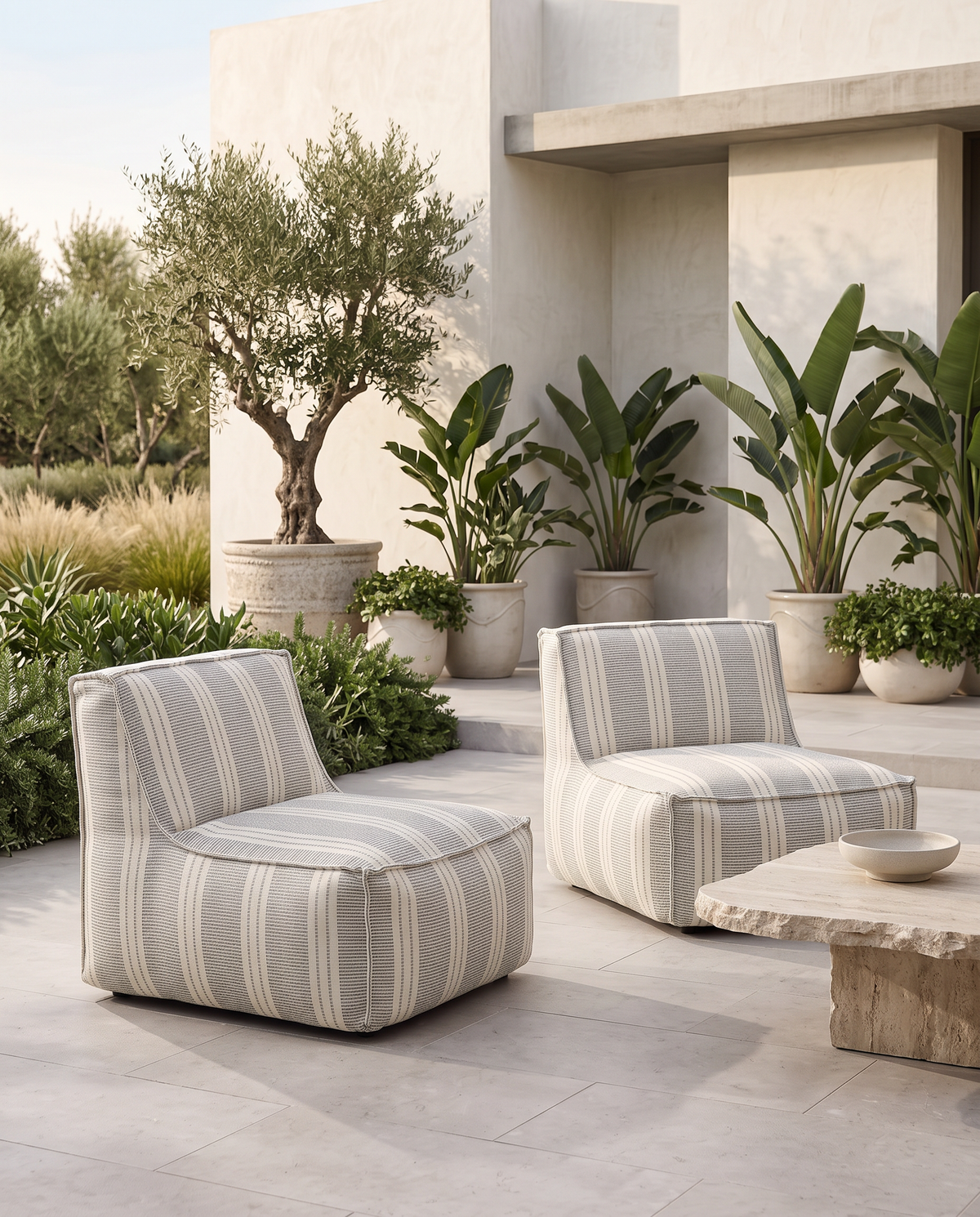 Cove outdoor lounge chair in blue and ivory Dobby Stripe fabric, styled outdoors