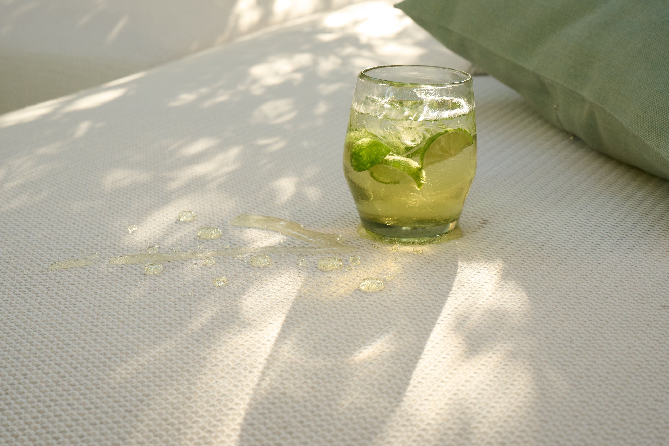 A drink spill beading on light Sunbrella upholstery fabric